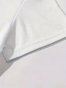 Detailed shot of plain white short sleeve t-shirt hem, neat stitching, premium fabric quality.