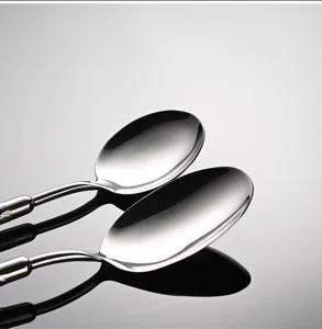 Stainless steel tablespoon close up view, highly polished mirror finish cutlery for dining table.