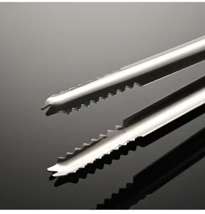 Stainless steel ice tong detail view, featuring serrated anti-slip grip for kitchen use.