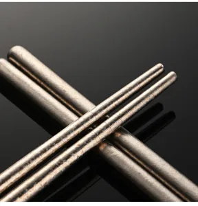 Pure titanium lengthened cooking chopsticks detail view, showing crystal texture and fine finish.