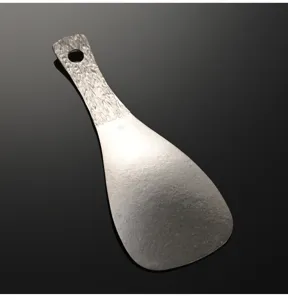 Detailed shot of pure titanium square rice spoon with textured handle and hanging hole.