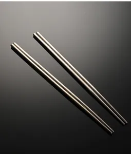 Detailed close-up view of premium metal cooking chopsticks showcasing sleek texture.