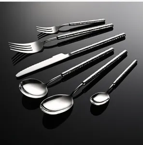 Premium stainless steel cutlery set featuring elegant hammered handles for dining.