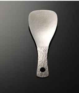 Pure titanium rice paddle detail, textured handle design, premium kitchen tool for daily cooking.