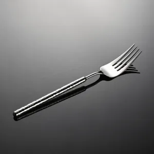 Stainless steel dinner fork with hammered handle detail, premium cutlery for home and hotel use.