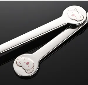 Dettaglio cucchiaio in acciaio inox con design koala, stoviglia elegante e resistente.