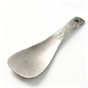Pure titanium square rice scoop with textured handle, durable kitchen serving tool for home use.