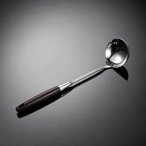Detail view of 316 stainless steel soup ladle with sleek wooden handle and polished finish.
