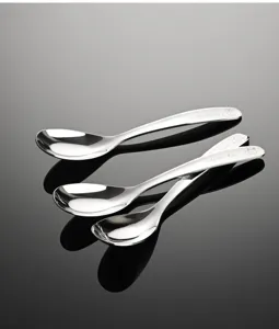 Stainless steel baby feeding spoon set with cute animal engravings for infant tableware use.