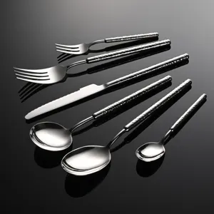 Stainless steel flatware set with hammered handles, elegant kitchen cutlery for home or hotel.
