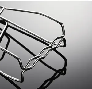 Stainless steel dish clamp detail view, heat resistant kitchen tool close-up shot.
