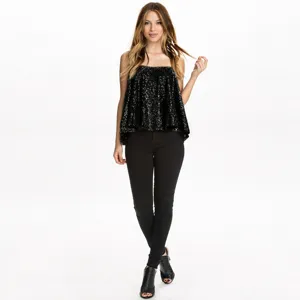 Detailed view of the black sequin camisole top featuring a loose fit and sparkly finish.