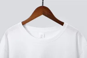 Detail view of a classic white cotton short sleeve men's t-shirt collar and neck label.