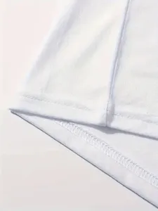 Detailed close-up view of white fabric hem and clean stitching for plain blank V-neck t-shirt.
