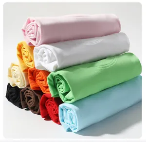 Close-up detail of neatly rolled colorful cotton short sleeve kids t-shirts in various vibrant hues.