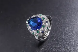 Vintage style pear-shaped blue synthetic gemstone ring with multi-color pavé zirconia details.