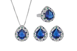 Detailed view of pear-shaped blue stone jewelry set with sparkling pave crystal accents.