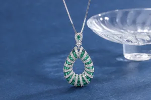 Elegant teardrop green gemstone pendant necklace with shimmering clear crystal paved details.