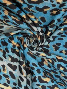Blue leopard print fabric detail shot showing the soft texture and vibrant blue pattern.