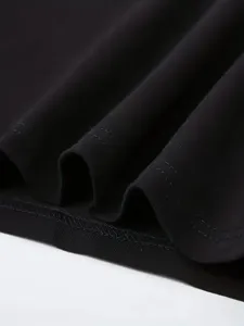 Detailed shot of black solid color fabric garment hem showcasing smooth texture and fine stitching.