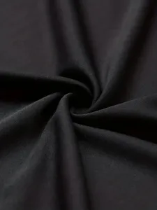 Close up of smooth black fabric material texture, perfect for apparel manufacturing details.