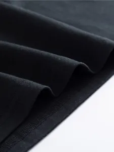 Close-up shot of black women's t-shirt fabric showing fine texture and neat stitching details.