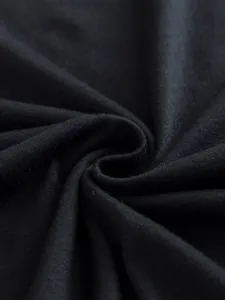 Black fabric texture detail of women basic solid color t-shirt close up garment view