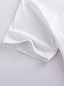 Close-up detail shot of white short sleeve t-shirt, soft cotton fabric with clean stitching.