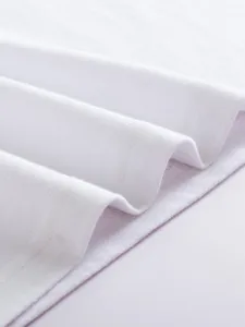 Close-up detail of women's white casual short sleeve top fabric texture and fine stitching craftsmanship.