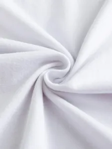 Close-up detail shot of soft pure white cotton fabric material showing fine texture.