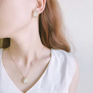 Elegante set di gioielli collana e orecchini a goccia in madreperla dorati da donna.