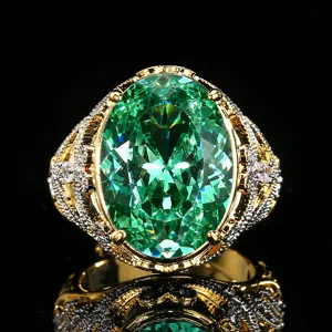 Detailed close-up of a vintage gold-plated ring with a large oval green gemstone.