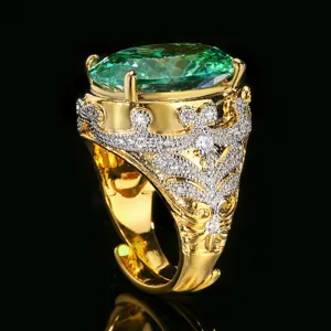 Detail view of vintage gold crown ring with large green oval gemstone and pave crystals.