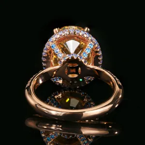 Vista di dettaglio di un elegante anello in oro rosa con gemma gialla e contorno blu.