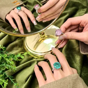 Detailed shot of the exquisite carved gemstone ring with pave setting and elegant hand wear.