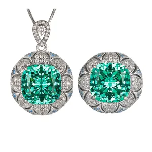 Detailed close-up of vintage cushion green gemstone jewelry set pendant and ring.