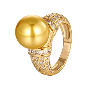 Primo piano dettagliato dell'anello con perla dorata e luminosi zirconi cubici scintillanti.