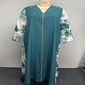 Detail view of plus size long sleeve robe with floral printed panels and gold trim V-neck design.