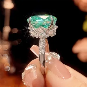 Millennium cut Paraiba green gemstone ring detail view, copper white gold plated micro-pave diamond band.