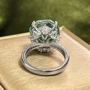 Detailed close-up shot of the stunning Millennium cut Paraiba green gemstone ring craftsmanship.