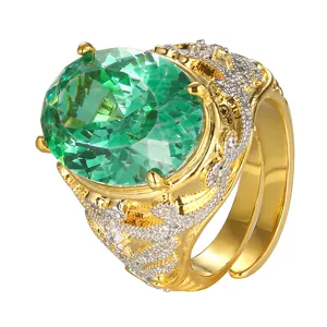 Close-up detail of vintage gold plated ring with large green oval gemstone and pave crystals.