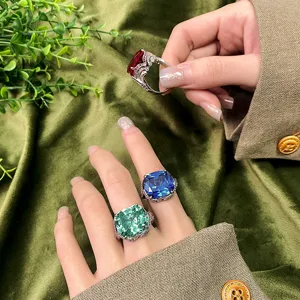 Detailed close-up of vintage cushion-cut gemstone rings with large simulated stones.
