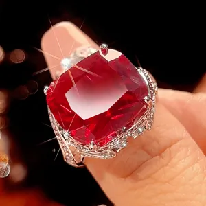 Detailed shot of vintage rectangular synthetic ruby ring with gold plated setting and sparkling stones