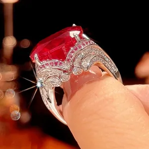 Vintage style square synthetic ruby ring with sparkling side stones, elegant gold plated detail.