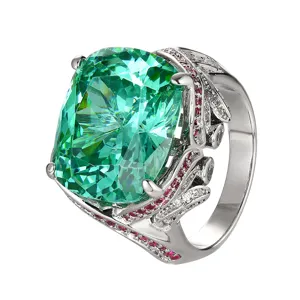 Luxury green cushion cut simulated gemstone ring with red and white pavé cubic zirconia details.