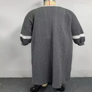 Detailed view of women plus size knit long sleeve dress with contrast stripe design.
