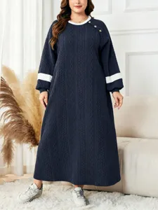 Detailed view of plus size long sleeve knitted long dress with stylish color block design.