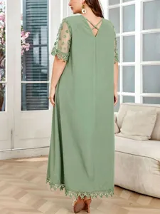 Detail view of sage green plus size maxi dress back with lace trim sleeves and V-neck design.
