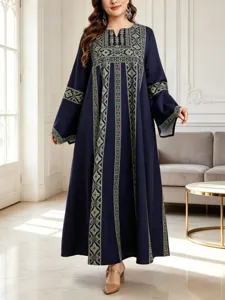 Detailed view of the dark blue ethnic print long robe, highlighting trumpet sleeves.
