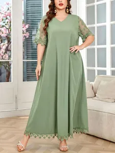 Detailed view of the plus size V-neck green dress with delicate lace short sleeves.